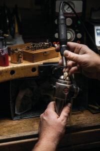 Jeweler using a rotary tool to polish a metal piece